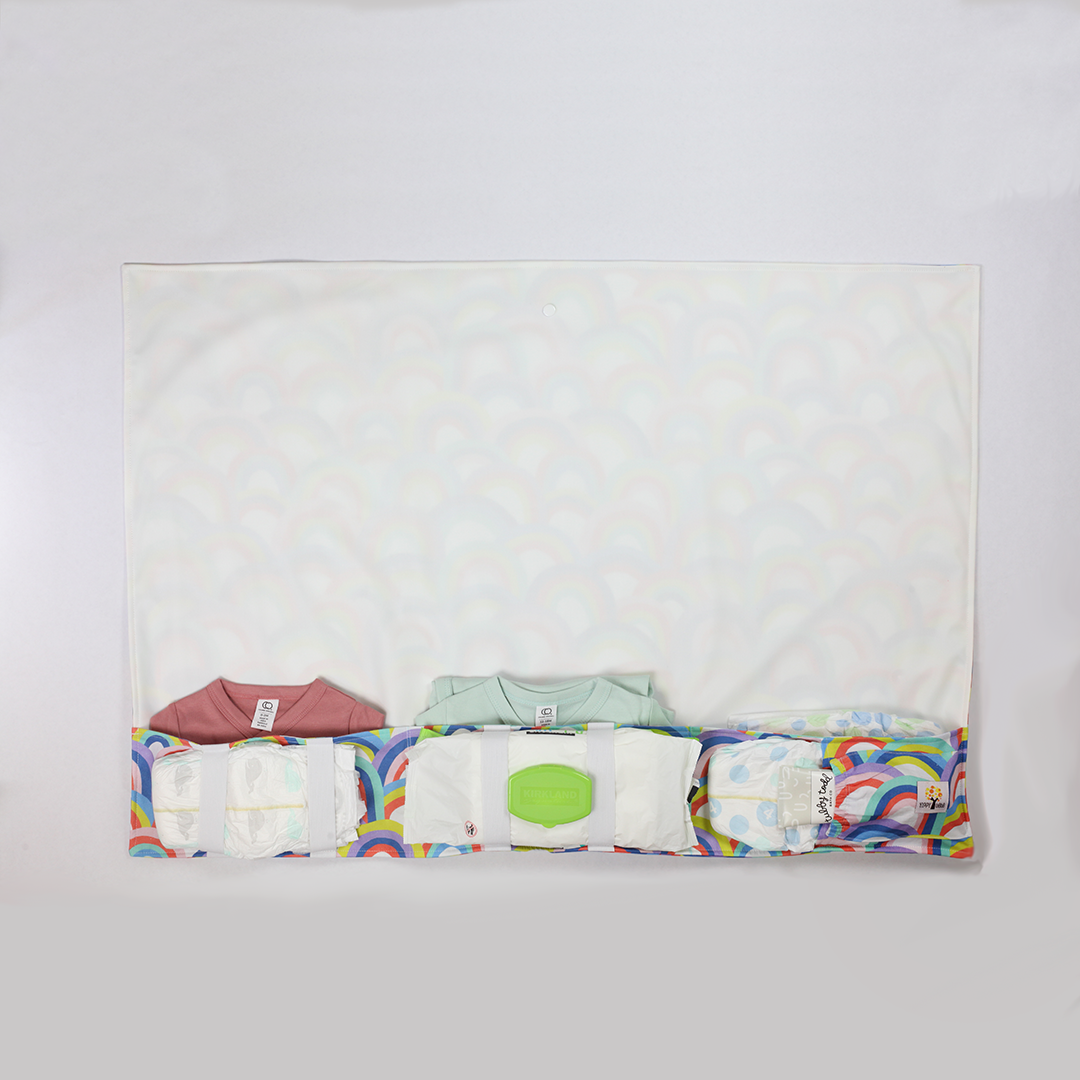full body changing pad filled with onesies, diapers, ointment, and baby wipes